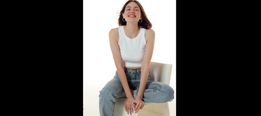 A girl sitting on a chair wearing earrings