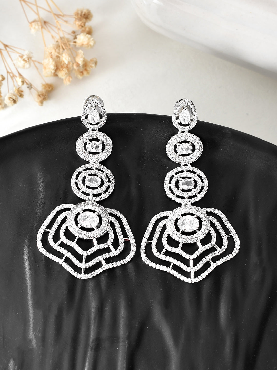 These American Diamond Cut work dangler earrings add a touch of elegance to any outfit. With intricate cut work and a sparkling finish, these earrings are perfect for any occasion. Crafted with precision and artistry, these earrings are a must-have for any jewelry collection