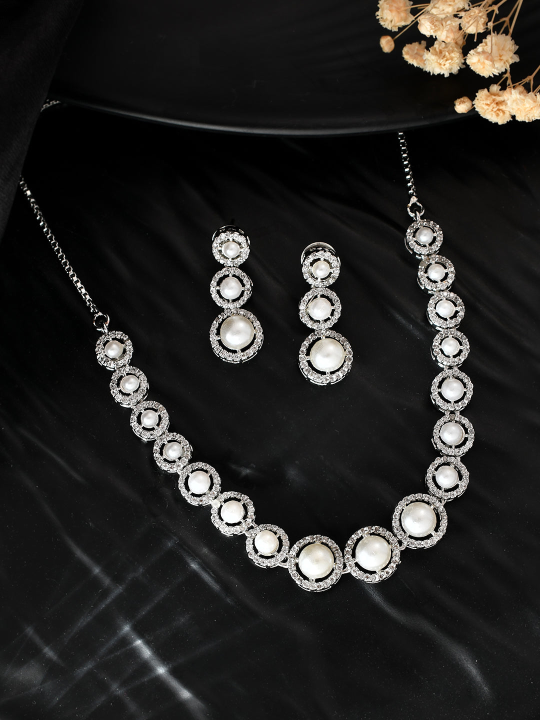 Shop This American Diamond jewellery set for women/girls features stunning and intricately crafted pieces that will elevate any outfit. Made with high-quality materials, this set exudes elegance and sophistication. Perfect for any occasion, this set will surely make a statement and add a touch of glamour to your look.