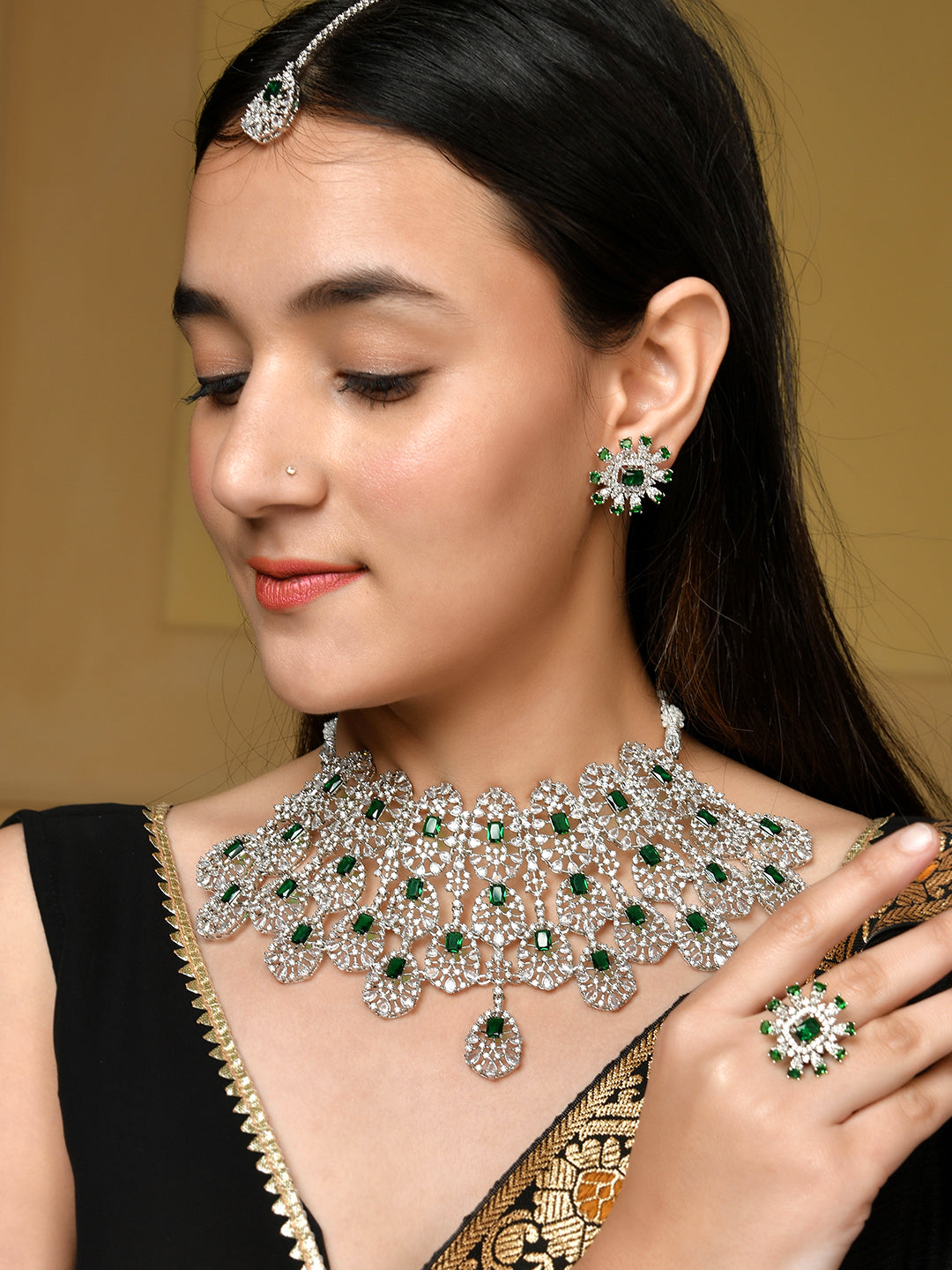 This stunning American Diamond heavy jewellery set with tikkka is the perfect accessory for any woman, bride or girl. With its intricate design and high-quality materials, it will add a touch of elegance and glamour to any outfit. Elevate your style with this beautiful set.