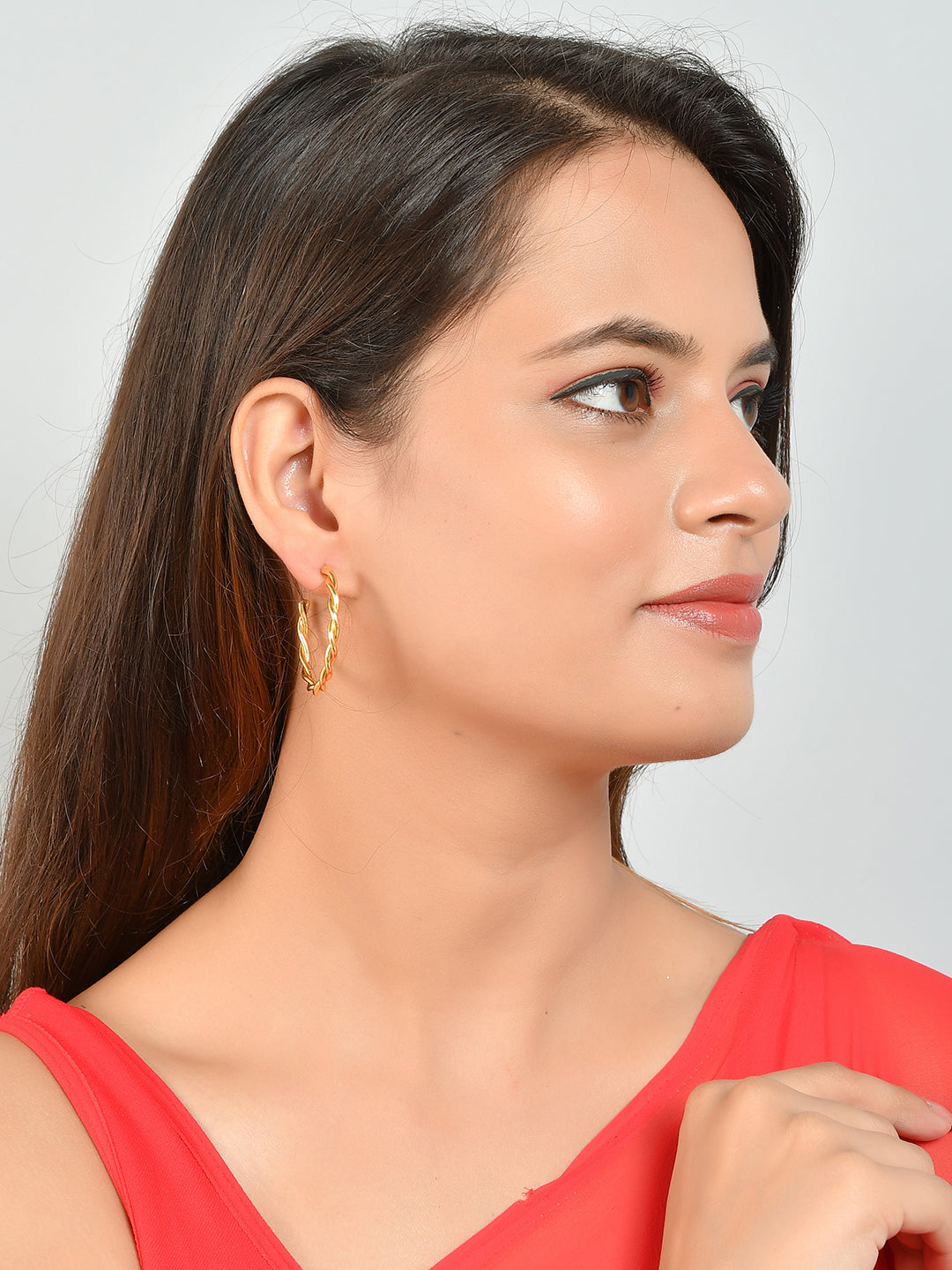 Experience elegance with our Gold Plated Varsha Twisted Earrings. Crafted with precision and plated in gold, these earrings are perfect for any occasion. With their unique twist design, these earrings are sure to add a touch of sophistication to your look